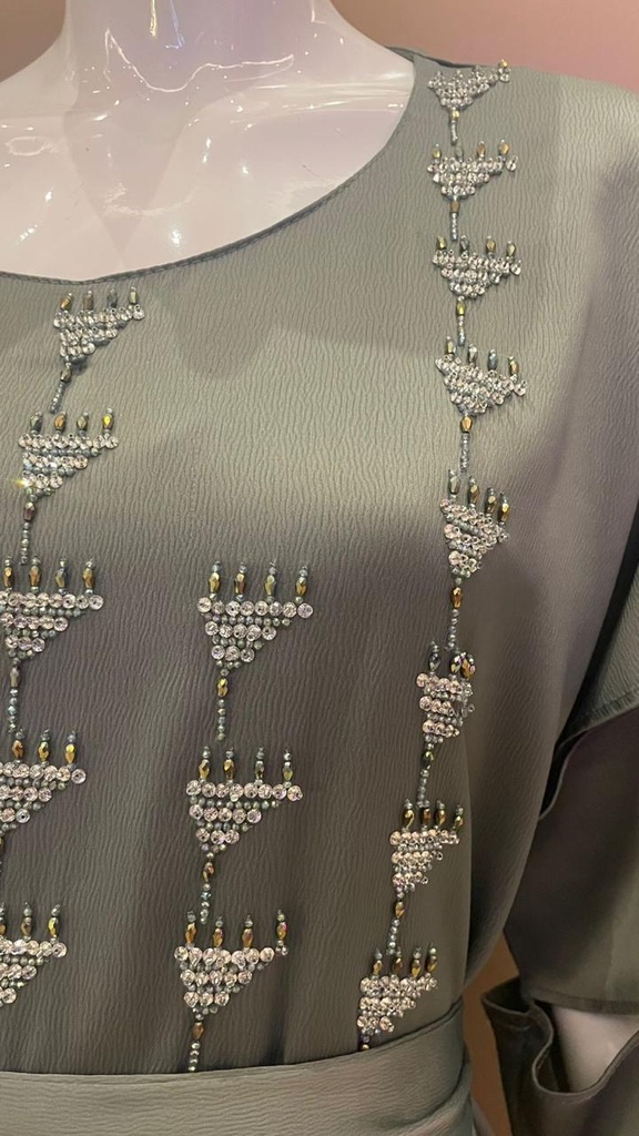Green dress embellished with an intricate silver beaded design