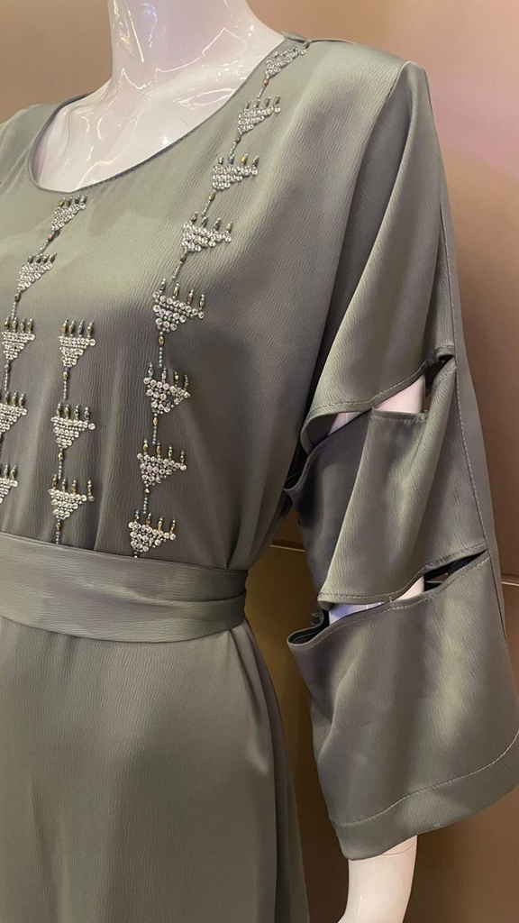 Green dress embellished with an intricate silver beaded design